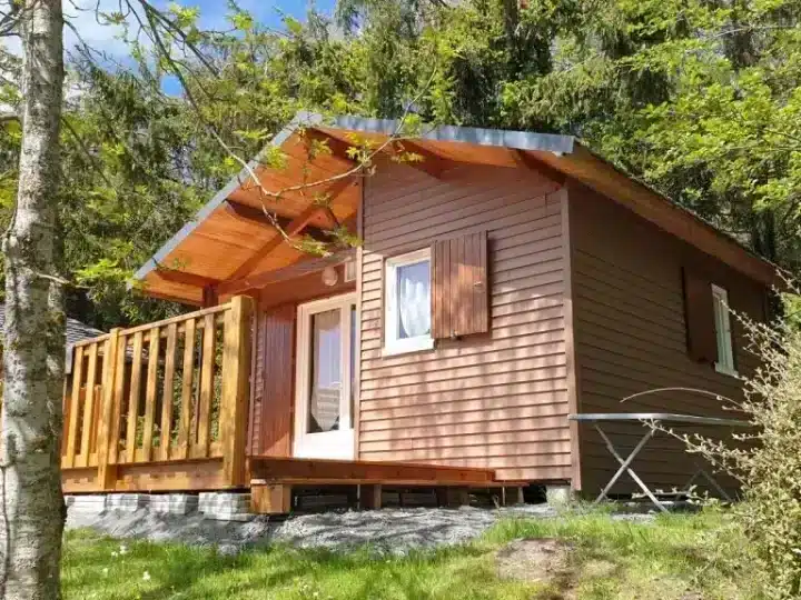 Small wooden cabin with porch in forest
