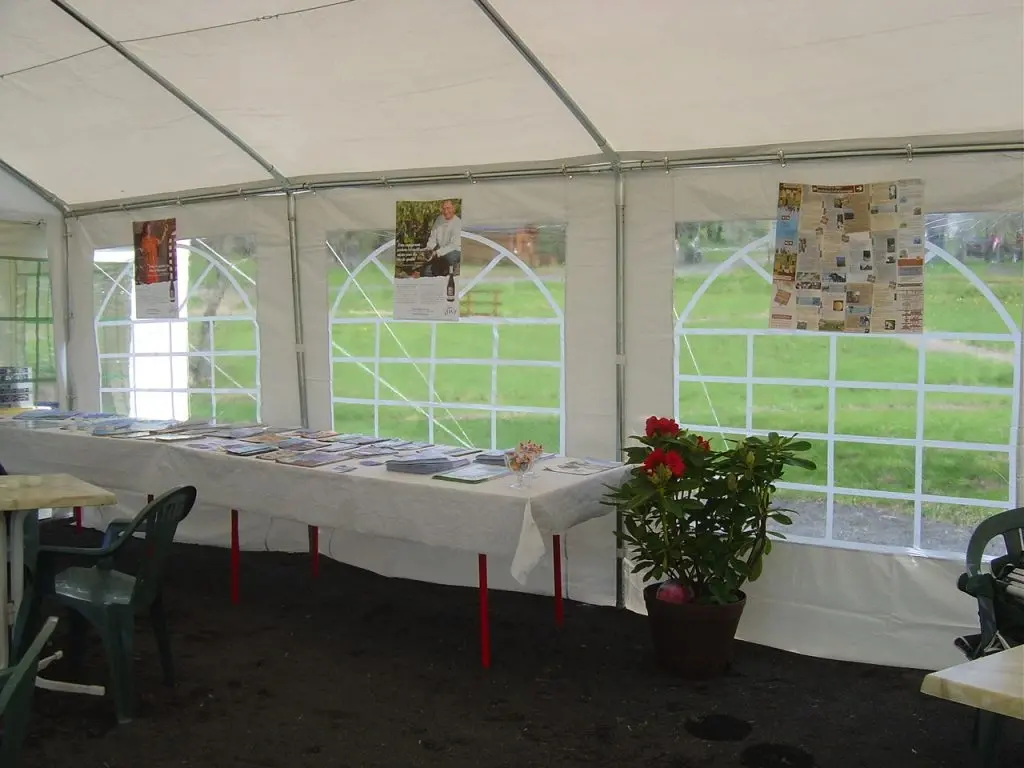 Tables with brochures inside white event tent