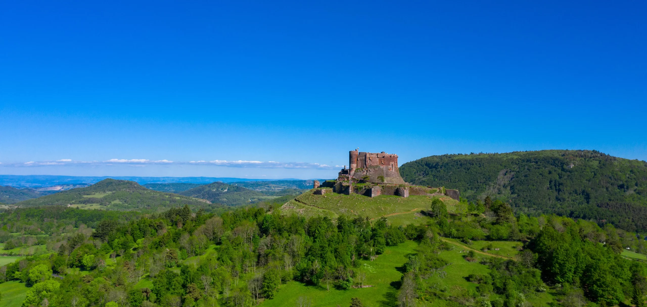 Hilltop castle overlooking lush green valley