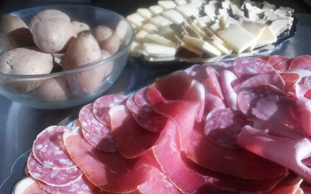 Charcuterie board with meats, cheese, and mushrooms