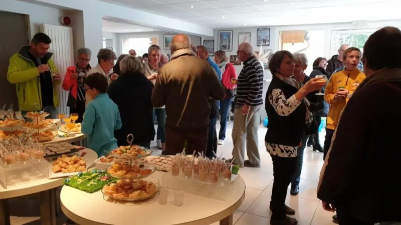 People gathered around buffet table at indoor event