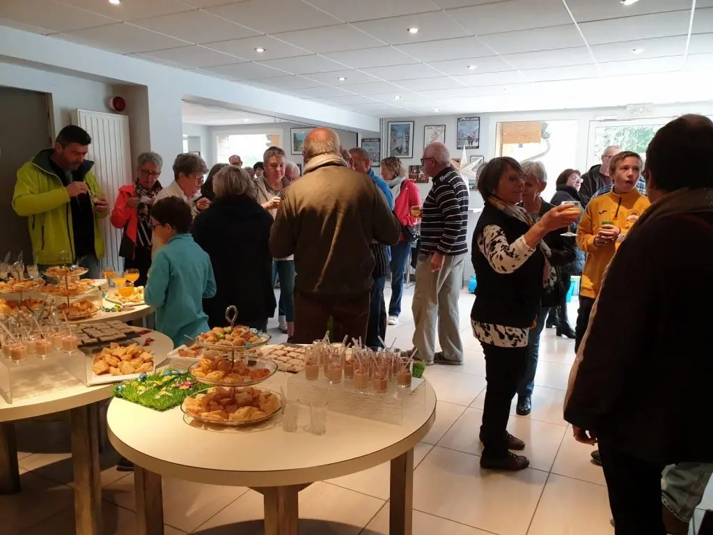 People gathered around buffet table at indoor event
