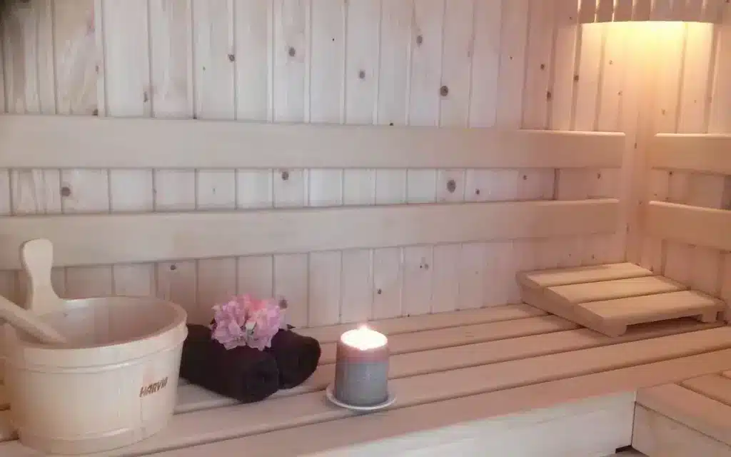 Cozy wooden sauna with candle and towels