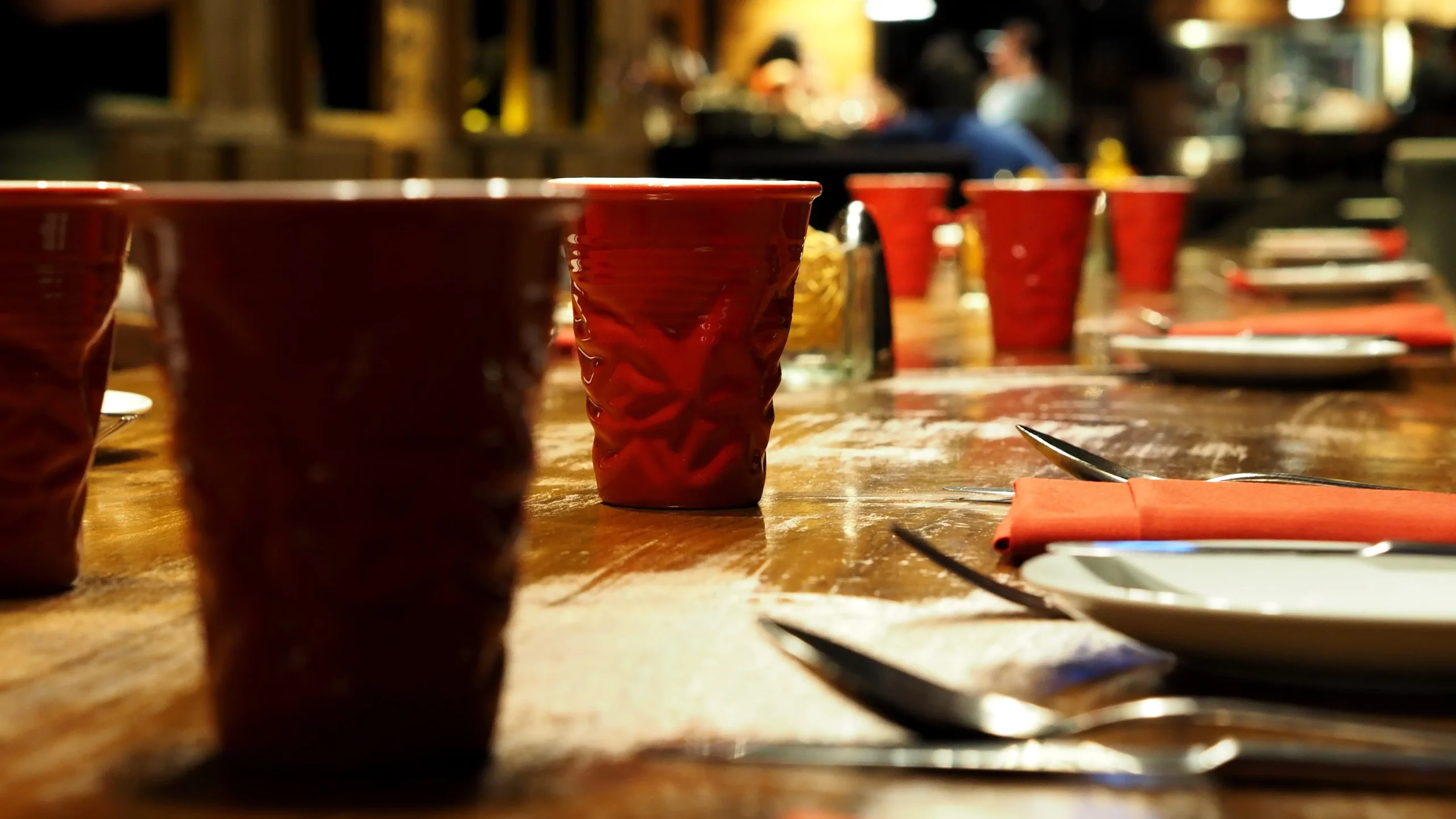Red plastic cups on wooden dining table