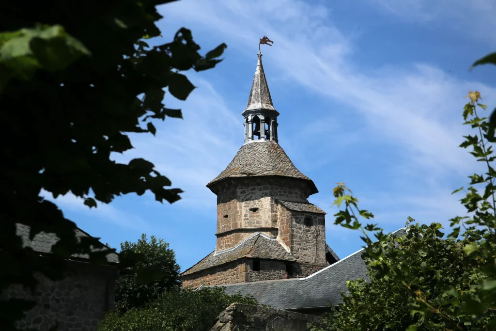 Historic stone tower with conical roof and spire