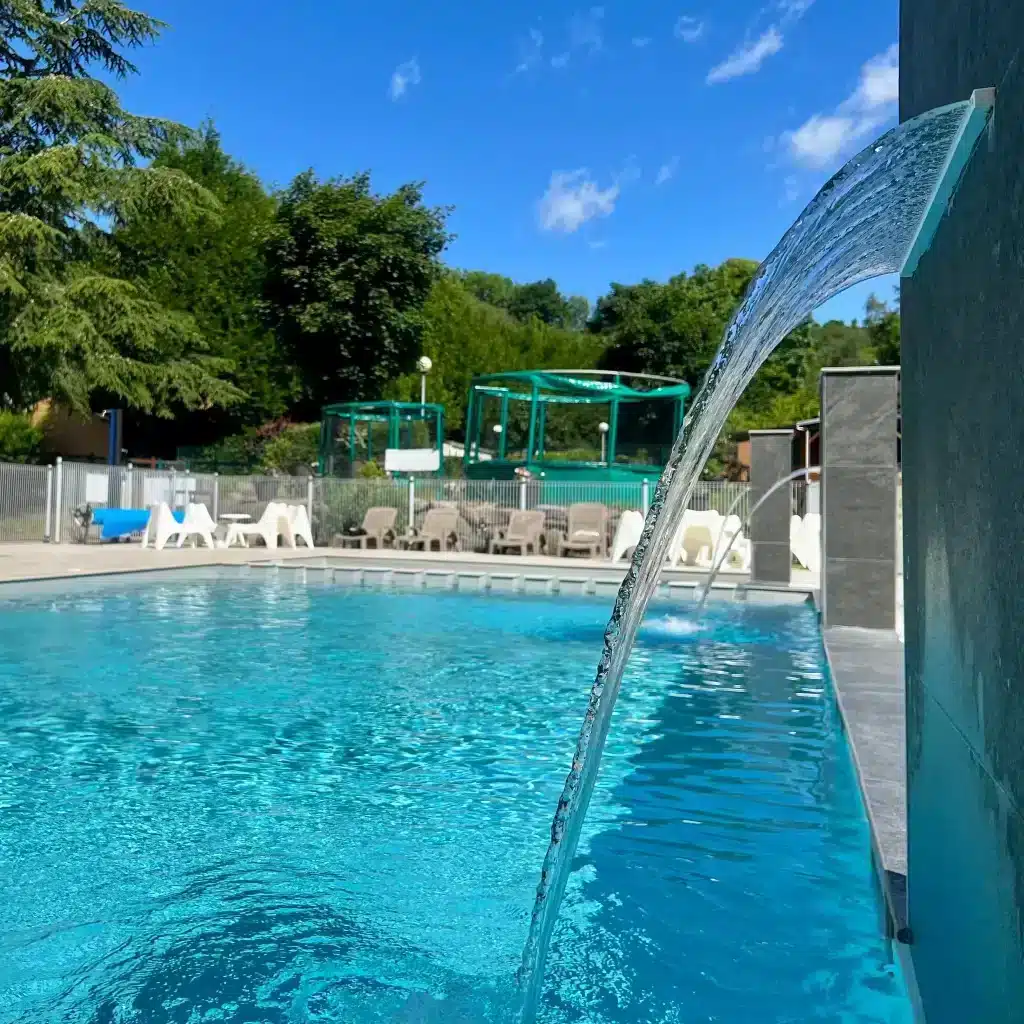 Outdoor swimming pool with cascading water feature
