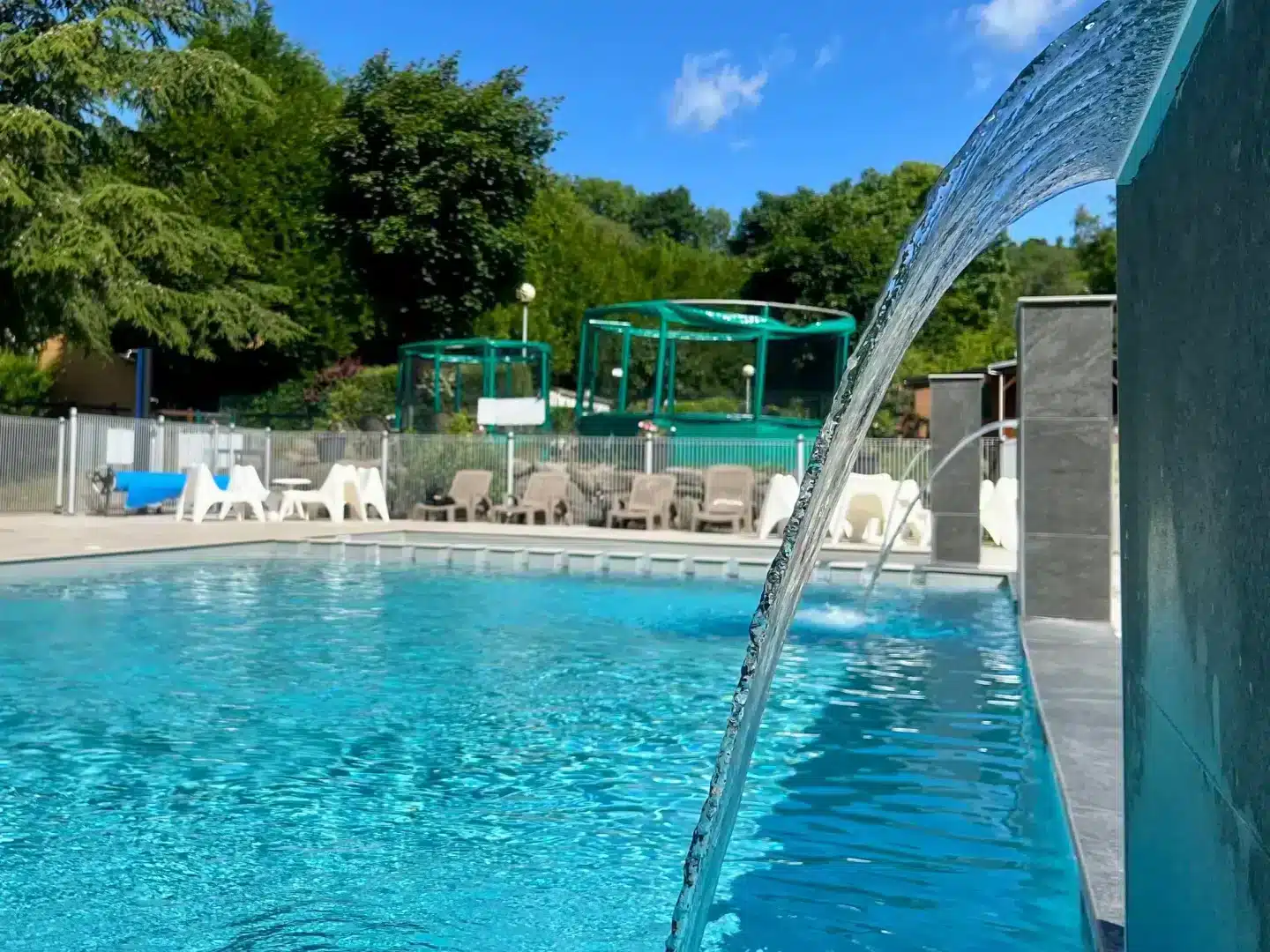 Outdoor swimming pool with cascading water feature