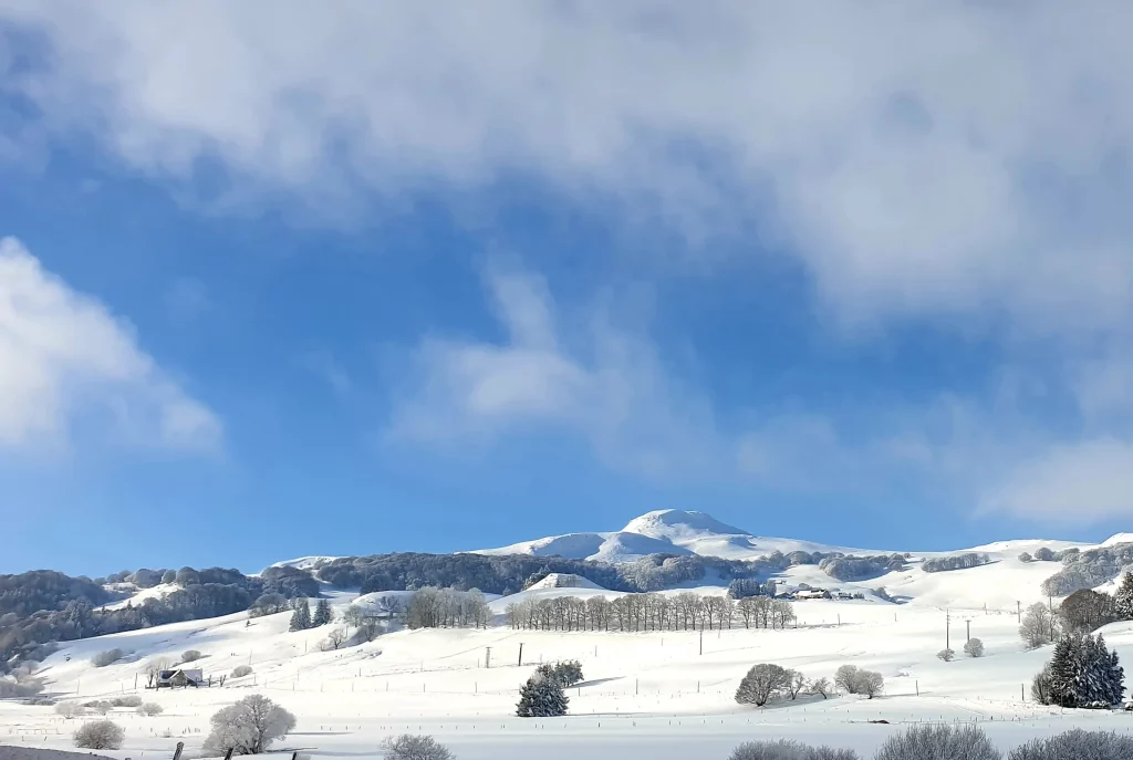 Snow-covered hills under bright blue sky