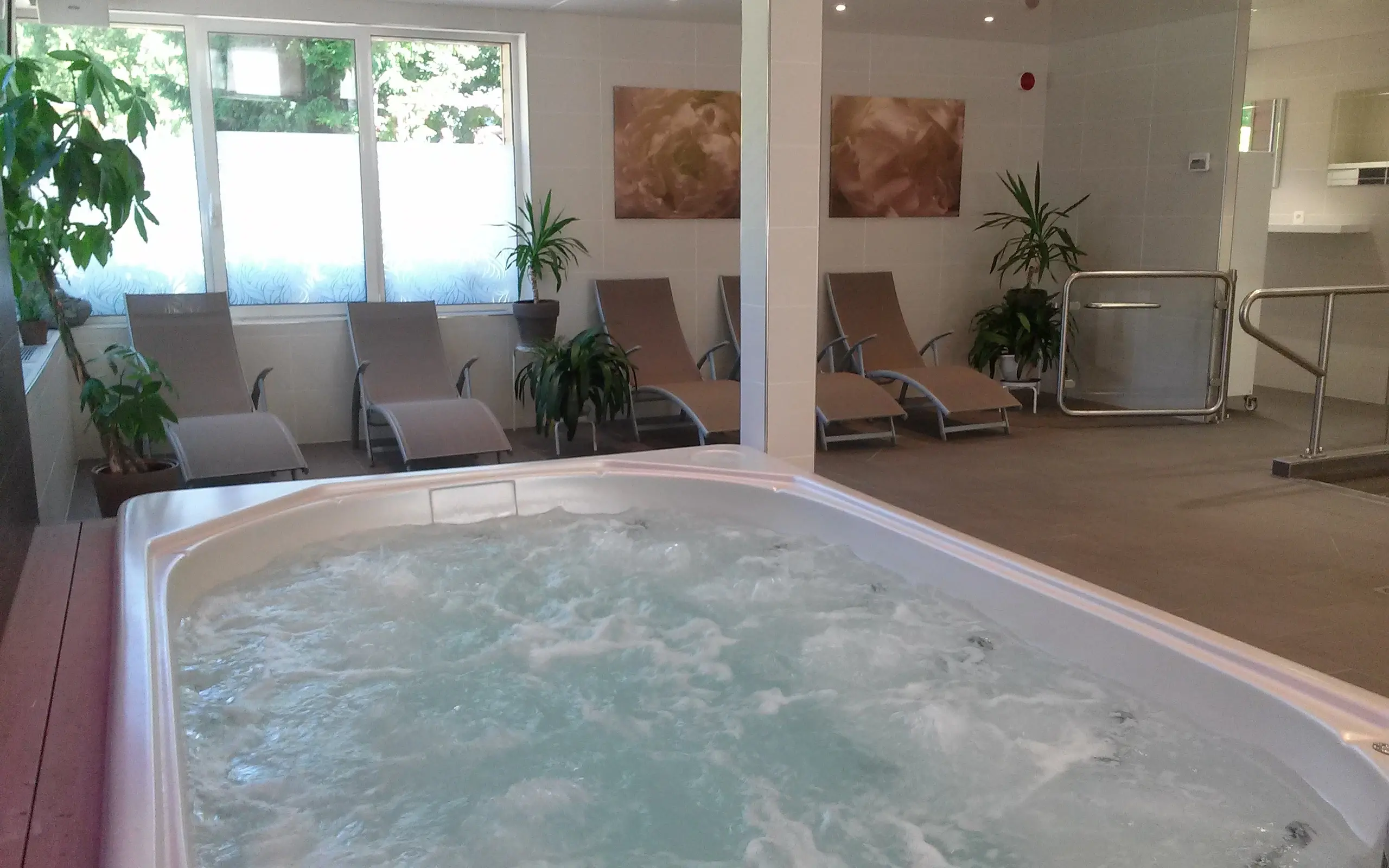 Indoor spa hot tub with lounge chairs