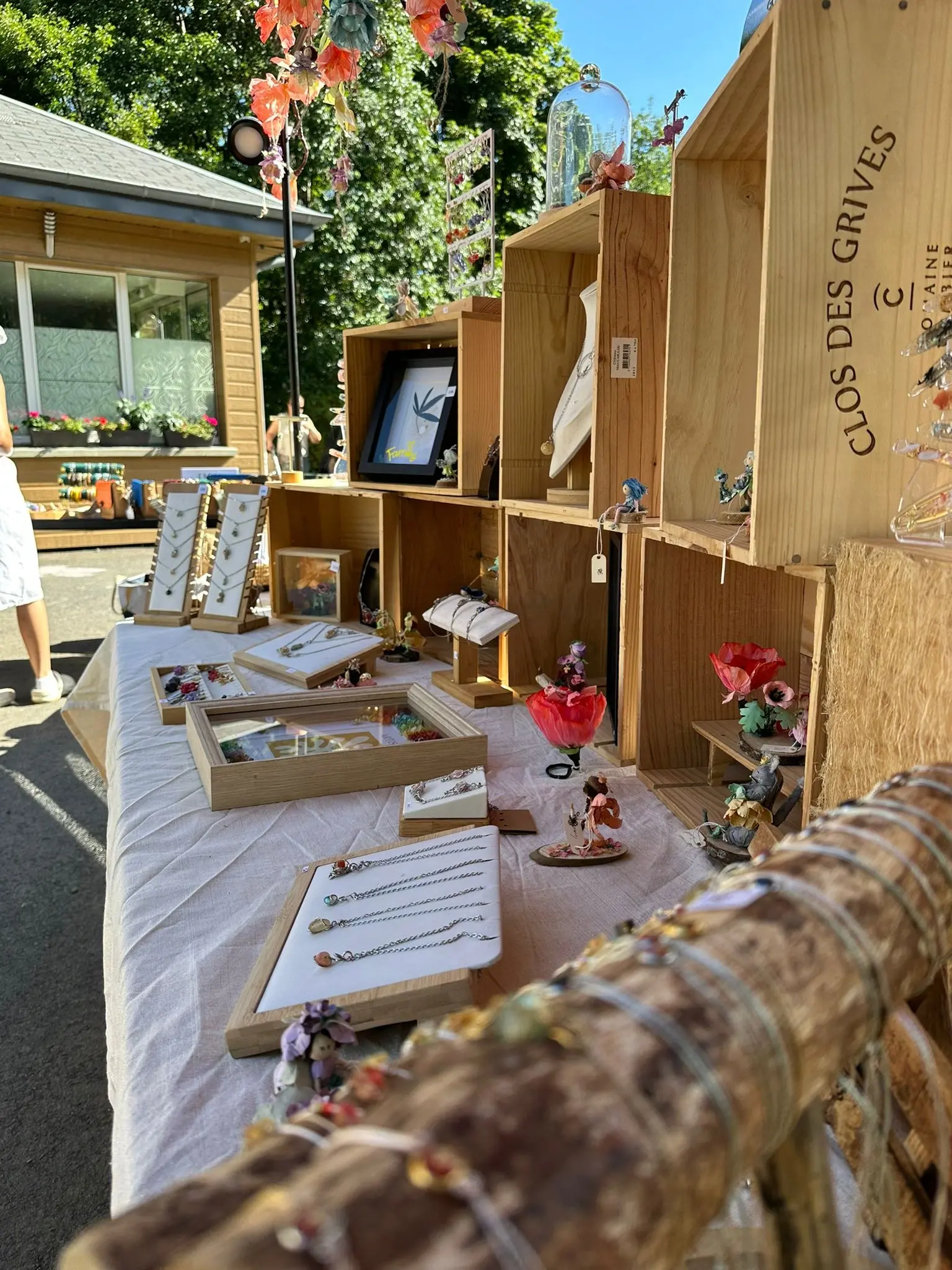Outdoor market stall displaying handmade jewelry and crafts