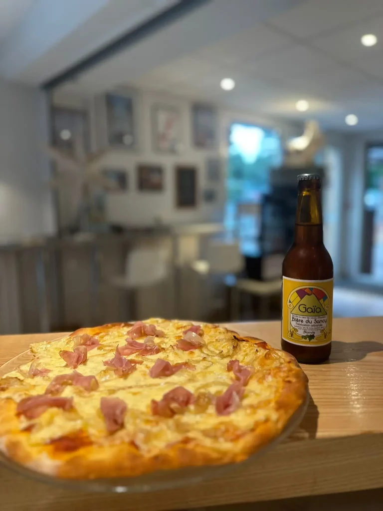 Ham and cheese pizza with bottled beer