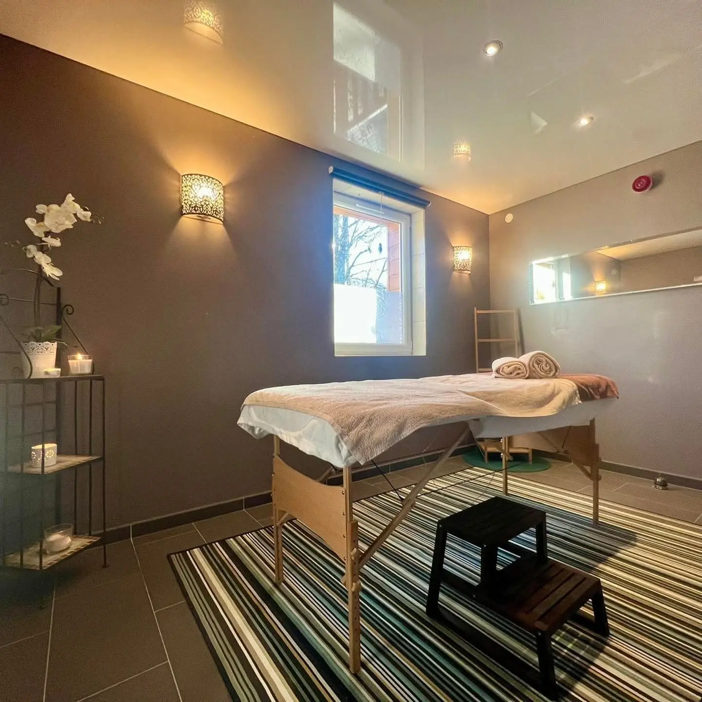 Cozy spa massage room with treatment table