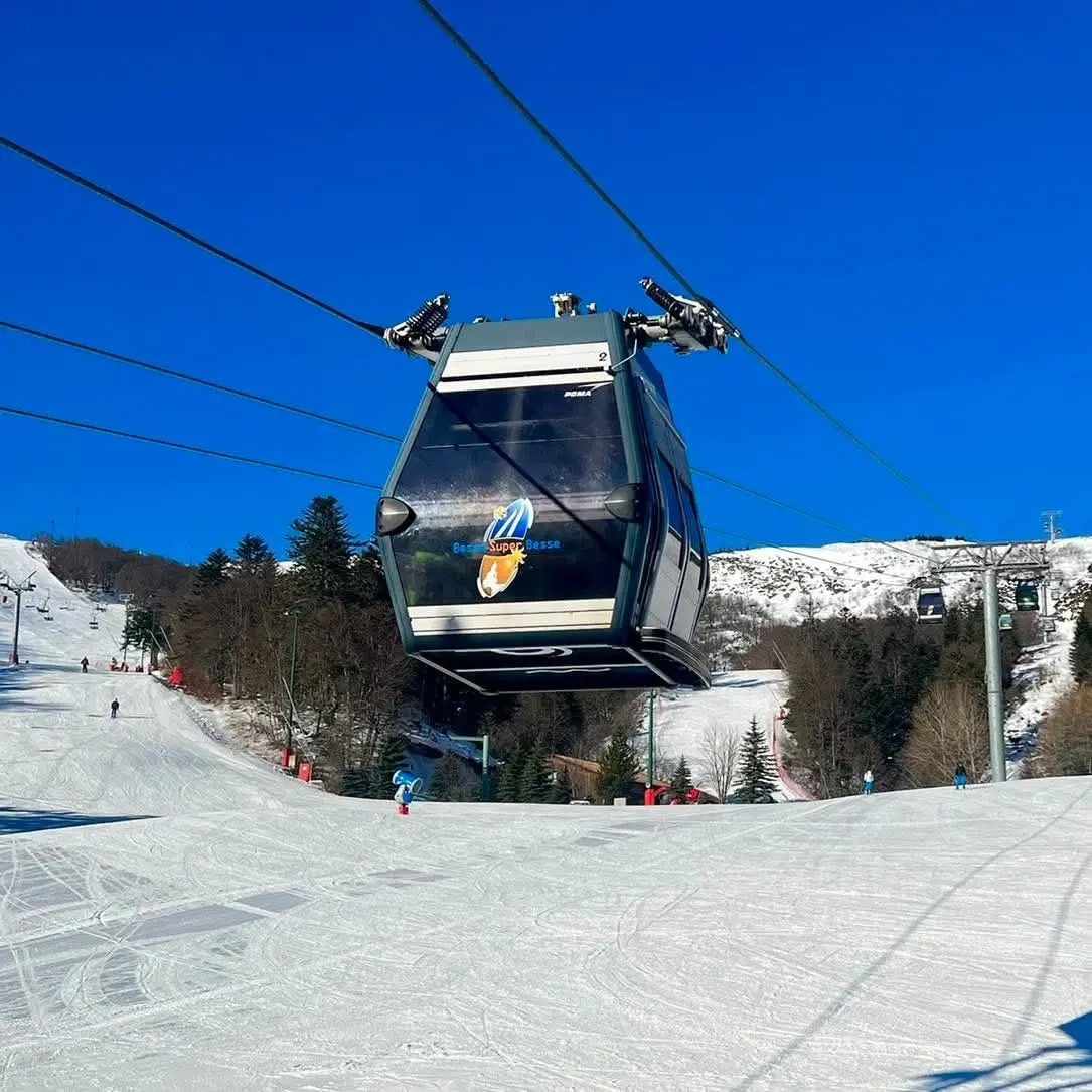 Gondola lift over snowy ski slope