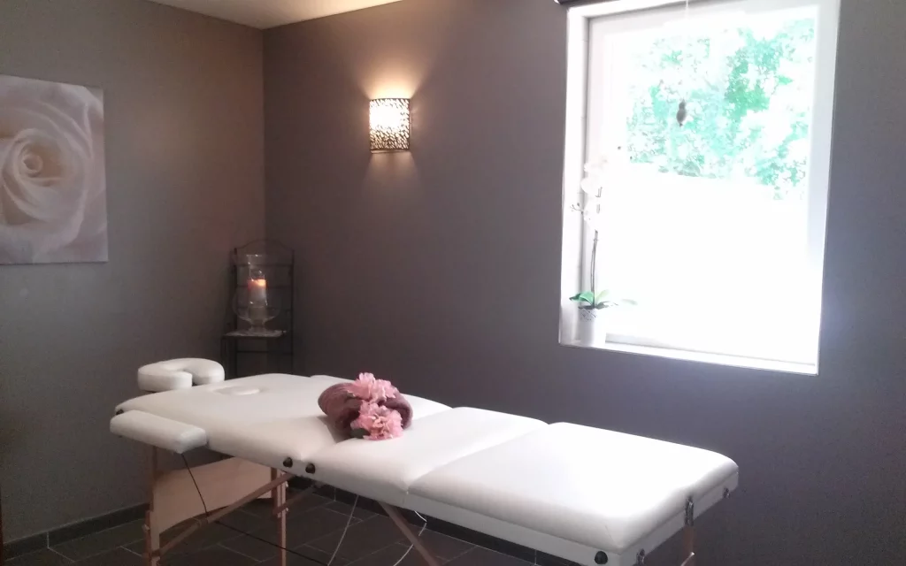 Serene massage room with table and soft lighting