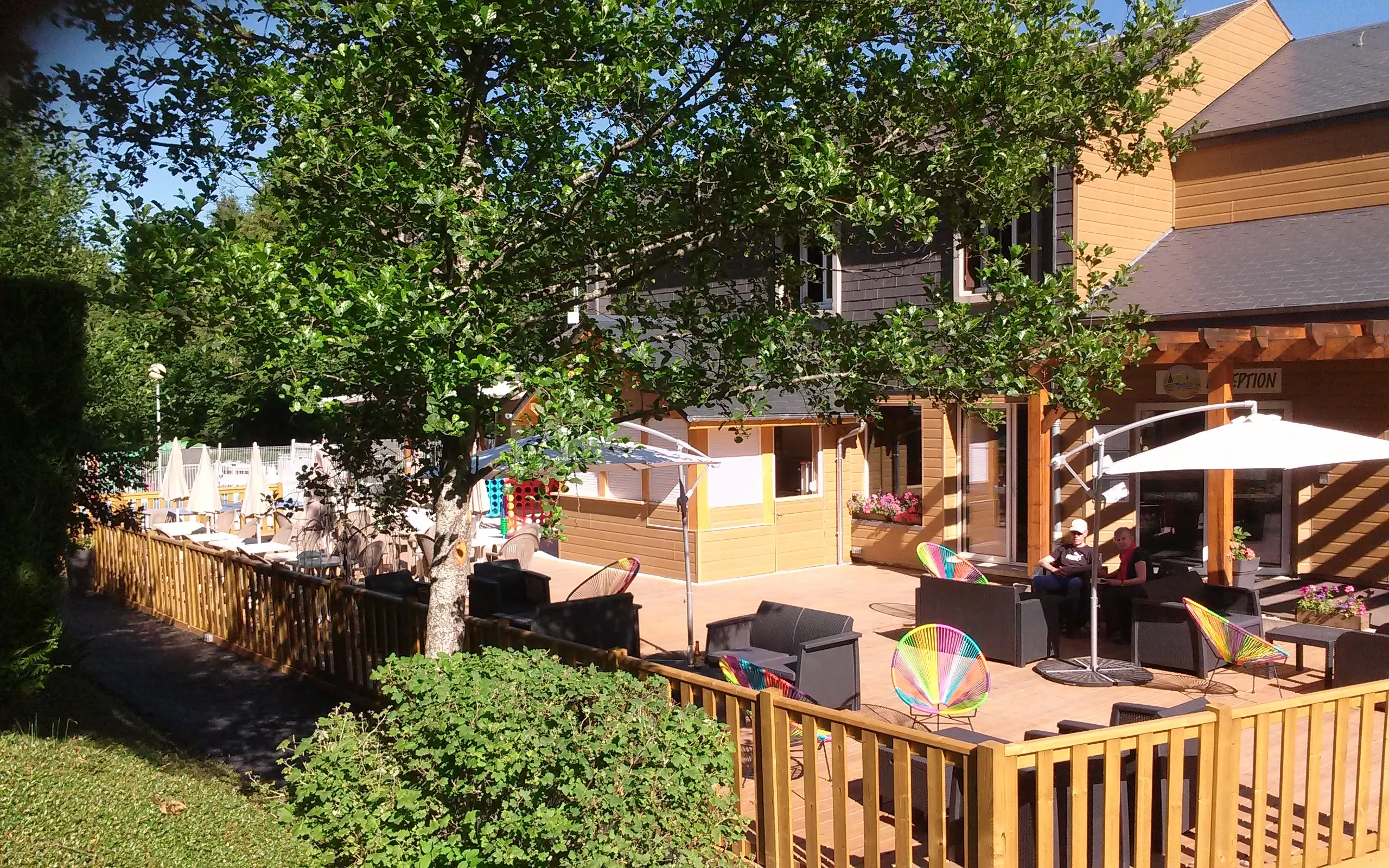 Sunny outdoor patio with colorful chairs and umbrellas