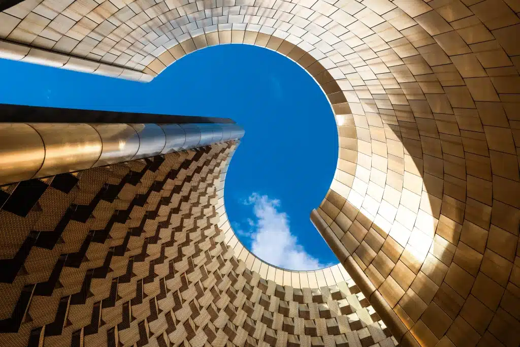 Curved golden architecture framing blue sky above